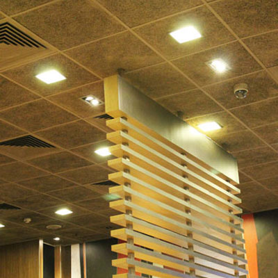 Nightclub acoustic treatment with sound-absorbing wall panels